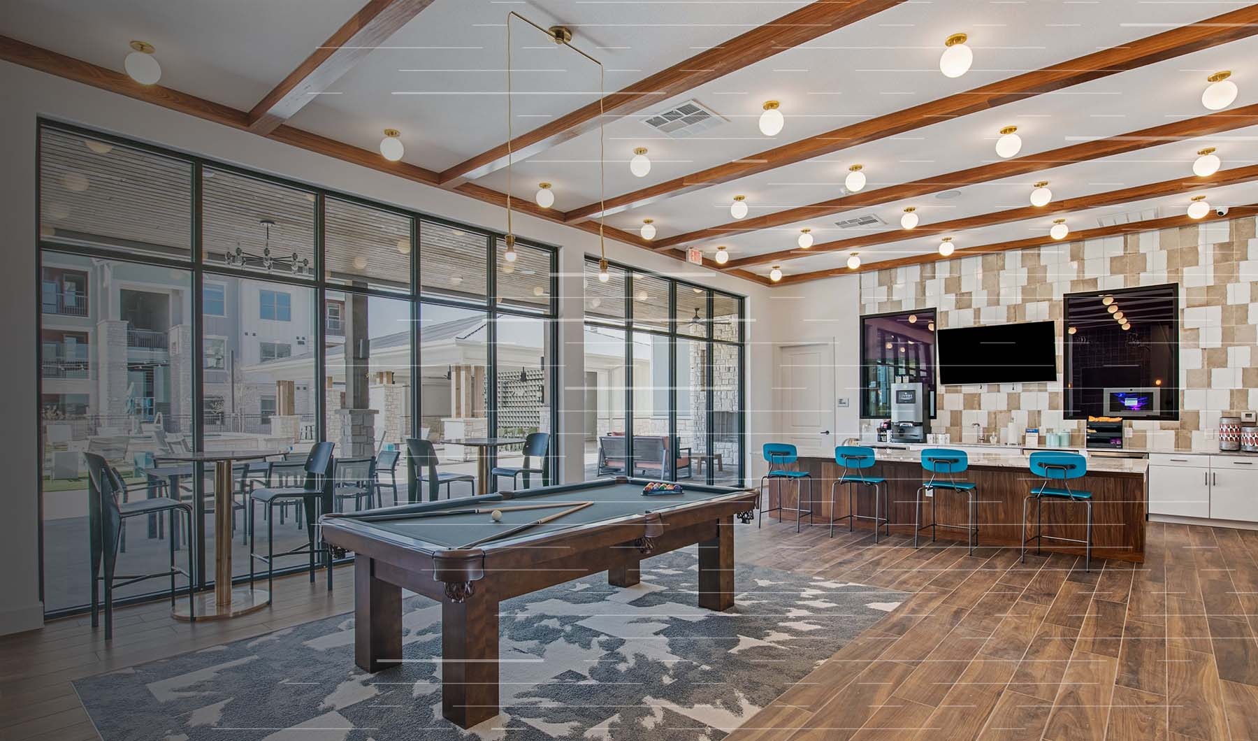 Lounge and dining room at our apartments in Midland, TX, featuring a billiards table, wood grain floor paneling, and seating. Lounge and dining room at our apartments in Midland, TX, featuring a billiards table, wood grain floor paneling, and seating.