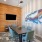 Conference room at our apartments in Midland, TX, featuring a conference table with blue chairs and a flat screen TV. 