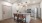 Model living room and kitchen at our apartments in Midland, featuring wood grain floor paneling and counter seating.