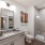 Model bathroom at our apartments in Midland, featuring grey countertops and a shower with sliding glass doors.