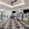Fitness center at our apartments in Midland, featuring weights, bench presses, a mirrored wall, and televisions. 
